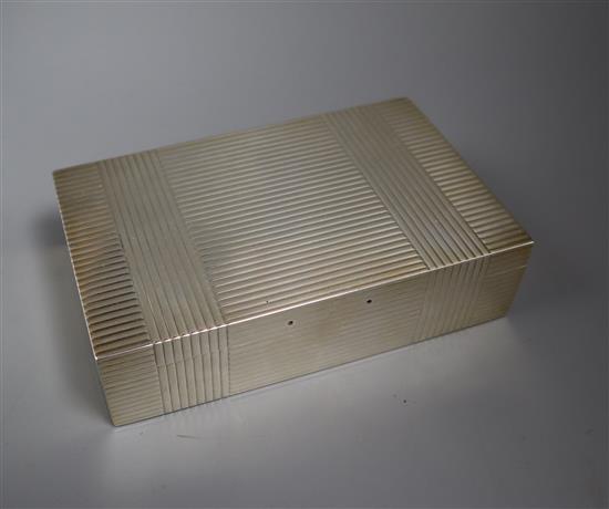 A George V ribbed silver rectangular cigarette box by Mappin & Webb, London, 1933 (handle missing?), 16.6cm.